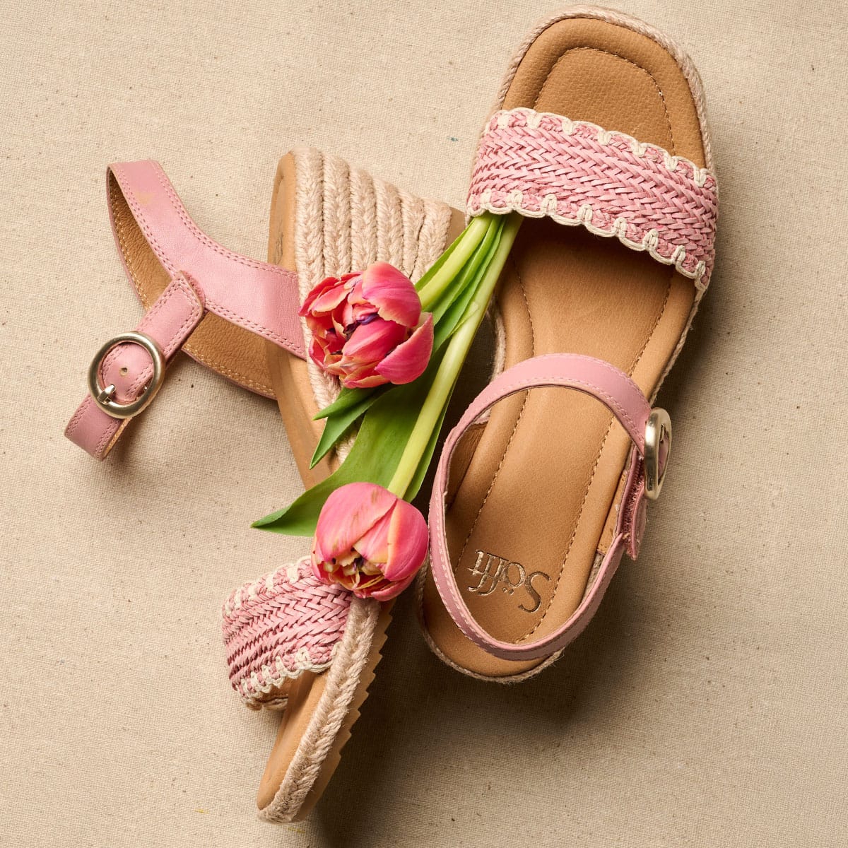 A pair of the Inez espadrille wedge sandals in pink with flowers.