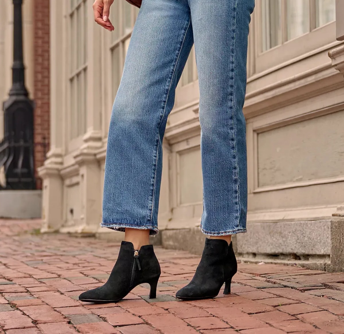 Featuring the Sasha kitten heel side-zip bootie in black suede.