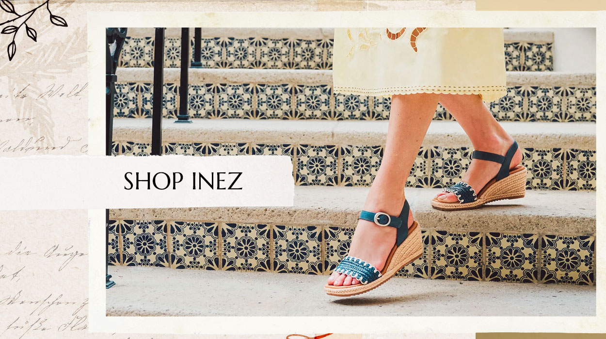 Woman walking down steps wearing the Inez sandal in blue. Shop Inez.